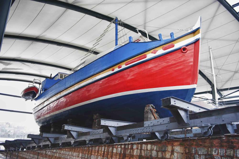 Large Boat Inside A Boatyard Next To The Sea