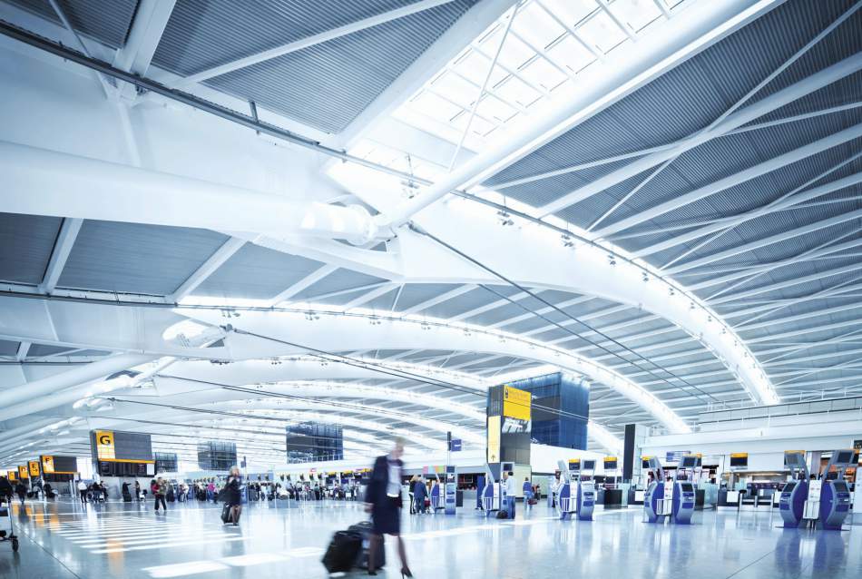 People Walking with Suitcases in Airport