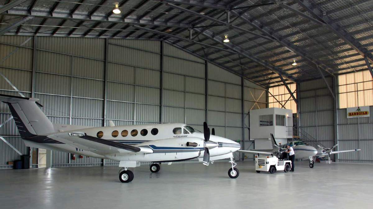Large Aircraft Hangar With Two Small Private Aeroplanes