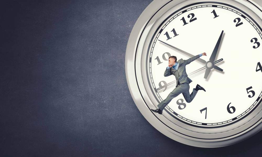 Man in Suit Jumping In Front of a Clock