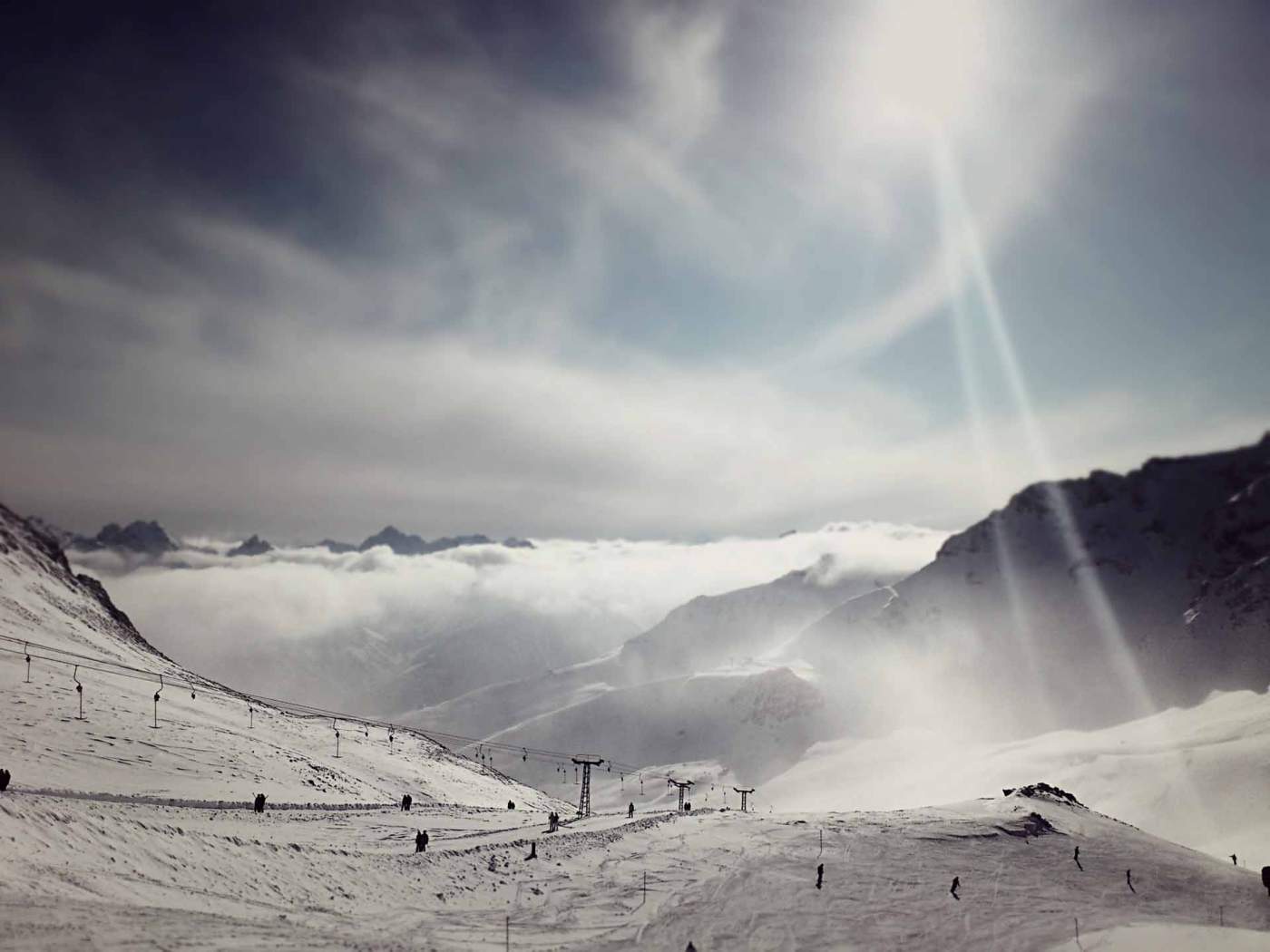 Ski Resort with Ski Lift in the Mountains and Clouds