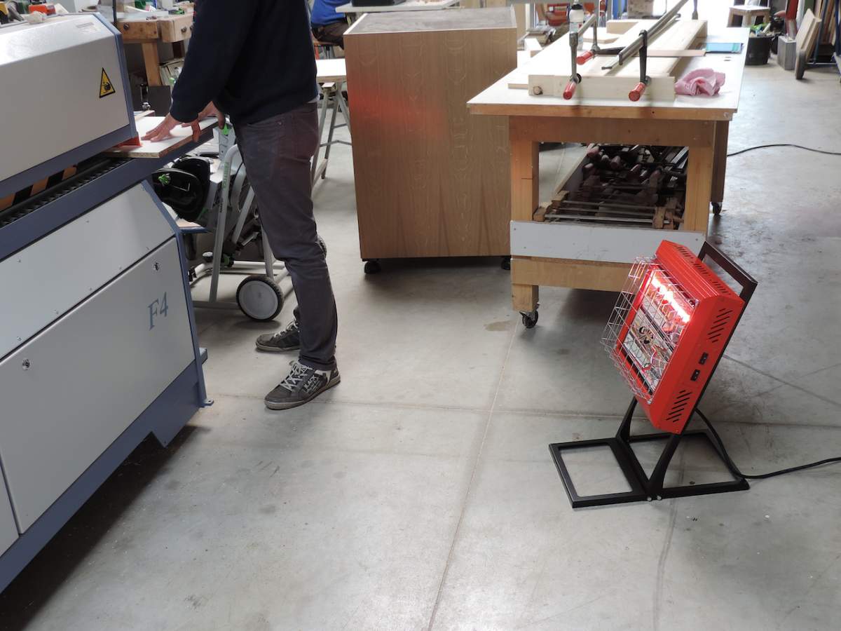 Tansun Beaver Portable Red Infrared Heater Heating a Worker Using Machine In Factory