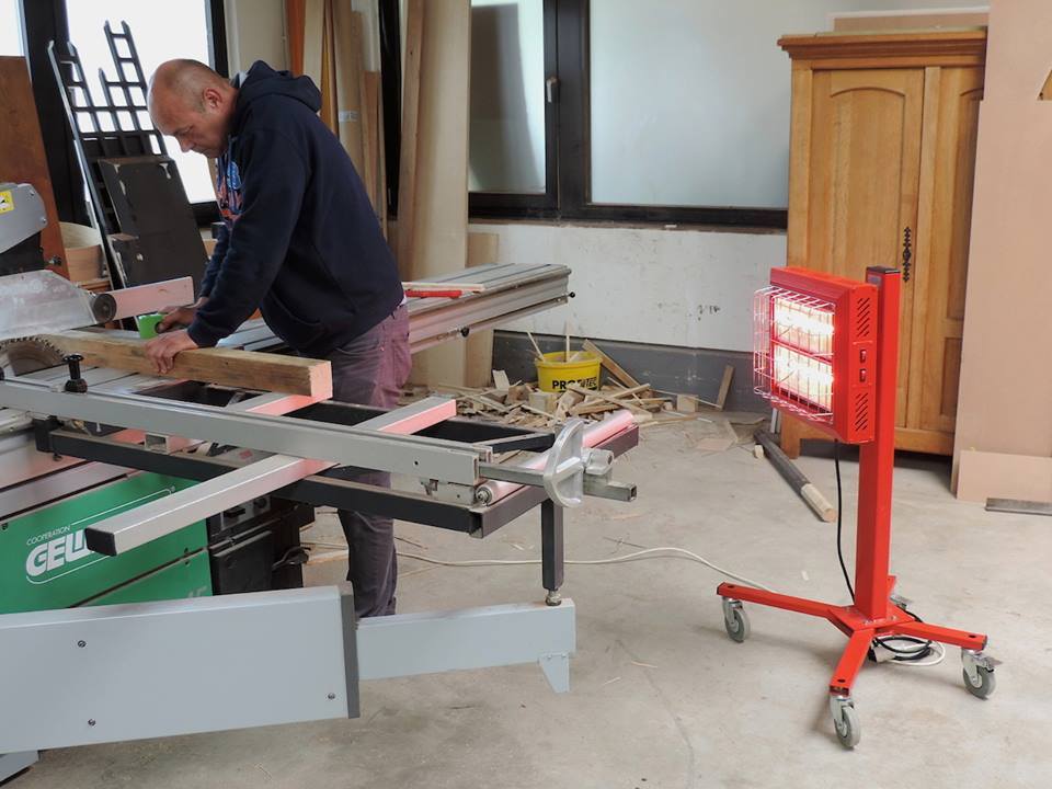 Tansun Spotter infrared building site heater heating worker in indoor construction area.